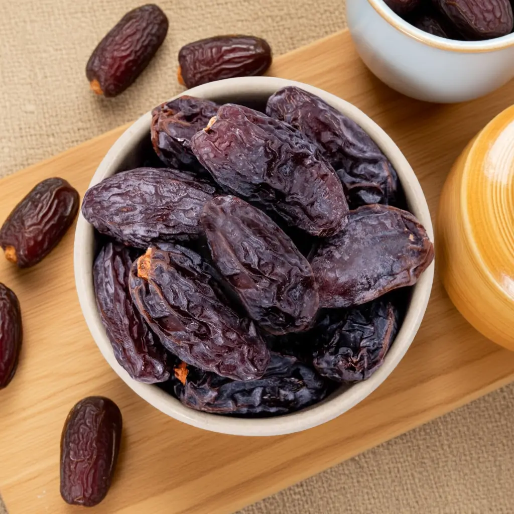 Medjool dates in a bowl on a wooden board