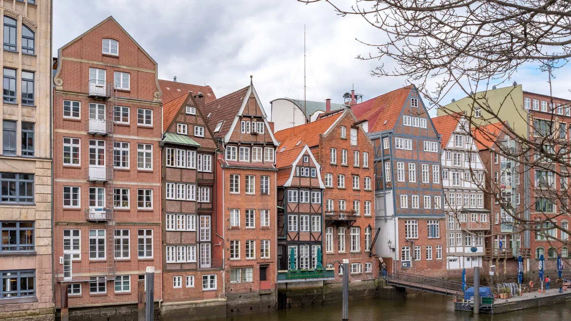 Tall row of half-timbered houses by a canal