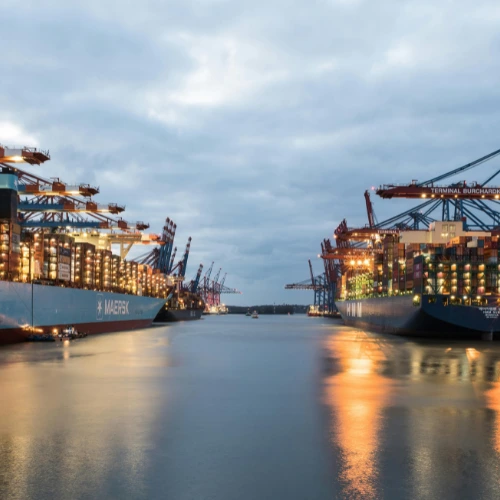 Two loaded, illuminated container ships at the container terminal